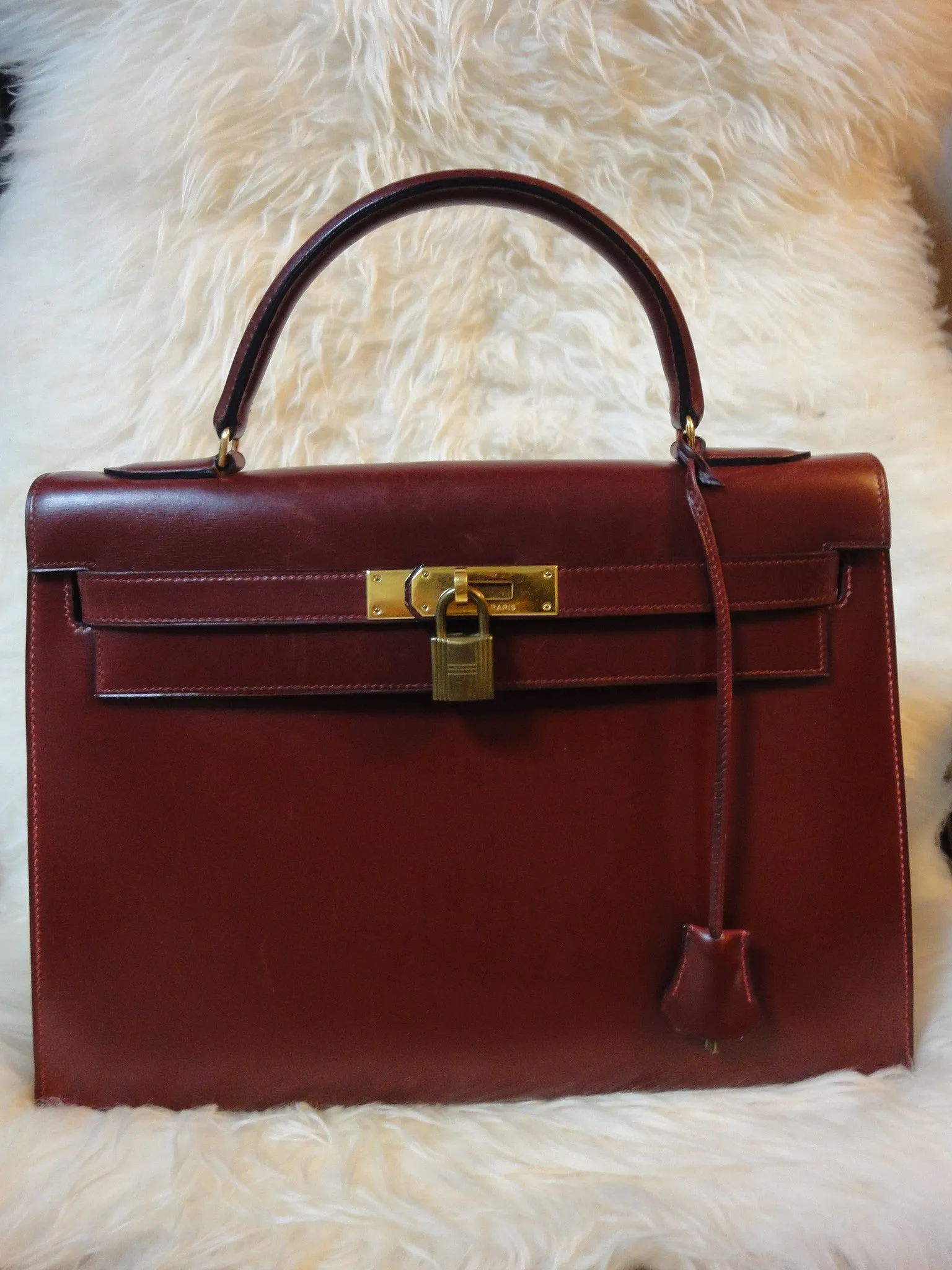1980s Vintage HERMES Kelly 32 bag rouge ash box calf leather with gold hardware. Exterior stitch. Stamp K in O, 1981. Best known classic bag